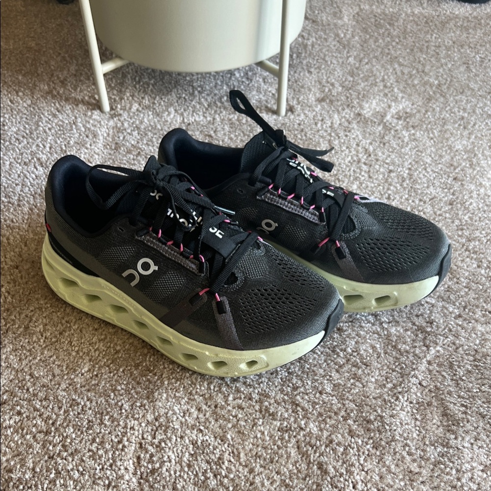 On Running Black Trainers with Pink Accents and Light Yellow Sole